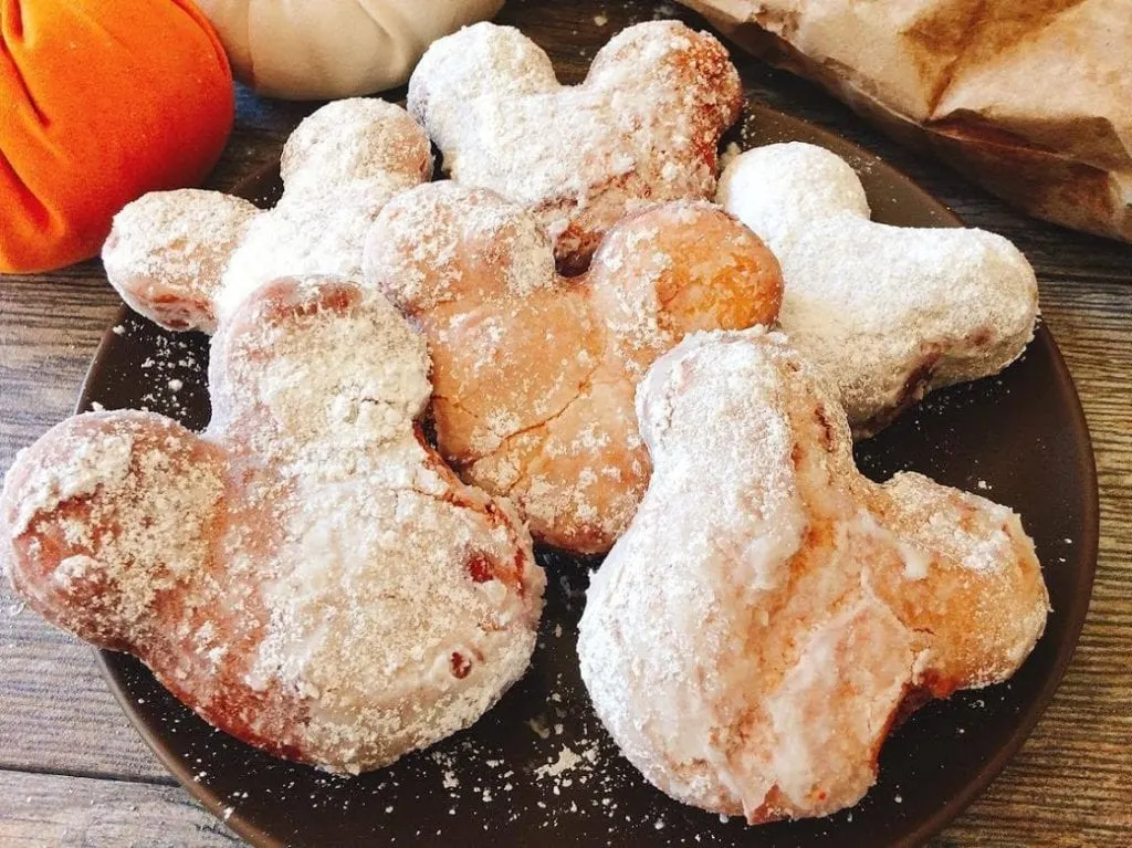 Mickey-shaped beignets with powdered sugar